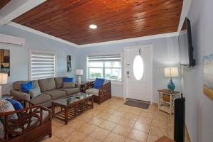 a living room with a couch and a table at Hideaways Exuma in Georgetown