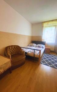 a small bedroom with a bed and a couch at Noclegi Lux Nysa in Nysa