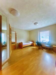 a room with a bed and a table and chairs at Noclegi Lux Nysa in Nysa