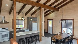 a kitchen and dining room with a table and chairs at Domaine Valga in Saint-Gabriel
