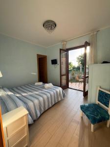 a bedroom with a bed and a door to a patio at I Due Melograni Agriresort in Tarano +82 photos
