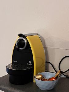 a black and yellow mixer and a bowl of utensils at The Arch House in Kymi