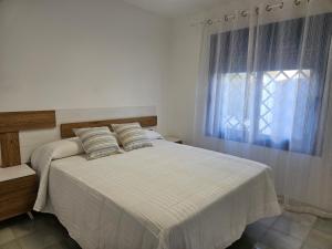 a bedroom with a large bed with a window at El sueño de Rocío in Roquetas de Mar +12 photos