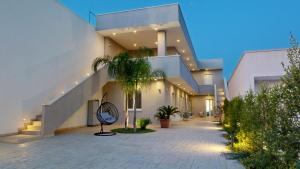 a hallway of a building with stairs and plants at MarèA25 in Porto Cesareo