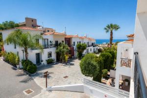arial view of a villa with palm trees and the ocean at Julipapas Gardens in Paphos