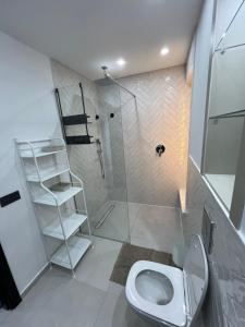 a bathroom with a shower and a toilet at Apparemment Martil Sofia bay in Martil +18 photos