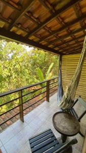 a hammock on the porch of a house at Pousada Cantarel in Maricá