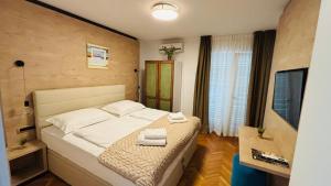 a bedroom with a bed with towels on it at Ava Apartments in Omišalj +58 photos