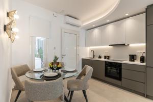 a kitchen and dining room with a table and chairs at Rafaela Casa Luxury Apartment Naxos in Naxos Chora