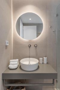a bathroom with a sink and a mirror at Rafaela Casa Luxury Apartment Naxos in Naxos Chora +13 photos
