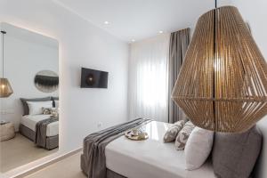 a bedroom with a bed and a large chandelier at Rafaela Casa Luxury Apartment Naxos in Naxos Chora
