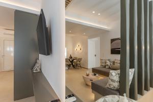 a living room with a tv on a wall at Rafaela Casa Luxury Apartment Naxos in Naxos Chora