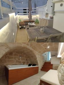 a kitchen and living room with a stone wall at Casa Perricci - short lets - Monopoli in Monopoli