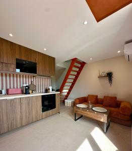 a living room with a couch a table and a staircase at LA BRISA Duplex chaleureux in Hyères
