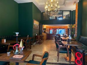 a restaurant with tables and chairs and a chandelier at Ethnica Hotel Old City in Istanbul