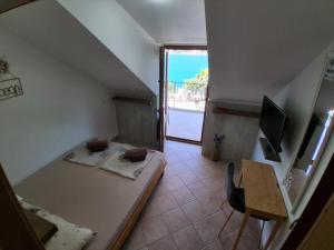 a room with a staircase with a desk and a table at Guesthouse Anita in Kotor