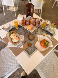 a table with breakfast foods and drinks on it at Diamond Rooms Tropea in Tropea
