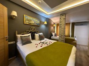 a bedroom with a large bed with roses on it at Ethnica Hotel Old City in Istanbul +46 photos