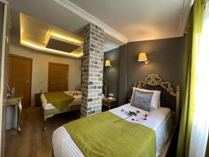 a hotel room with two beds and a chair at Ethnica Hotel Old City in Istanbul