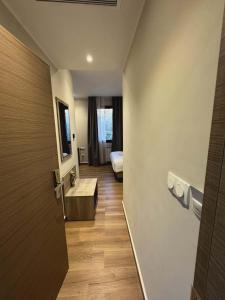 a hallway with a room with a bed and a door at Hôtel Corner King in Skikda +48 photos