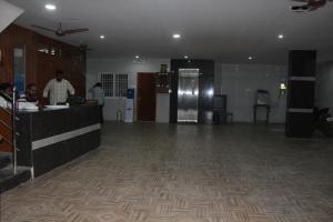 a lobby with a counter and people in a room at Hotel GVP Residency in Tirupati