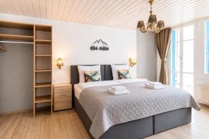 a bedroom with a bed and a book shelf at Hotel Restaurant Jungfrau in Lauterbrunnen