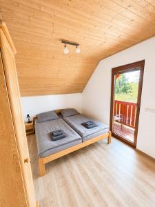 a bedroom with a bed in a room with a window at Kovarov26 in Frymburk