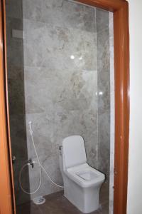 a bathroom with a toilet and a shower at Hotel GVP Residency in Tirupati +13 photos