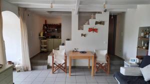 a kitchen with a table and chairs in a room at The Arch House in Kymi