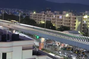 a bridge over a city at night with buildings at Hotel GVP Residency in Tirupati