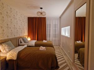 a hotel room with two beds and a mirror at Raunex Apartment in Haapsalu
