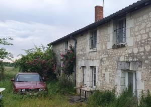an old car parked in front of a building at Le bois saint Hilaire in Lémeré +2 photos