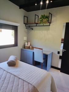 a bedroom with a bed and a desk and a chair at Casa do Bem Estar Picada Café in Picada Cafe