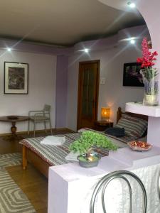 a bedroom with a bed and a table with flowers on it at Central Home in Piatra Neamţ