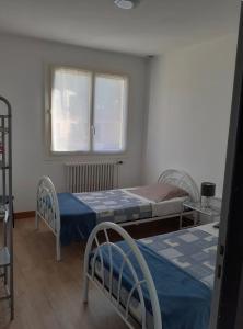 a bedroom with two beds and a window at Maison Treize vents in Treize-Vents