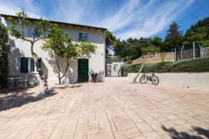 a bike parked in front of a white building at Spitaki Pool House & Spitaki Jacuzzi Deluxe Suite in Corfu