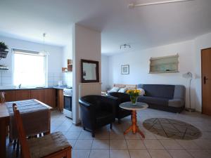 a living room with a couch and a table at Willa Puchatek in Gąski
