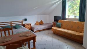 a living room with a couch and a table and a couch at Willa Puchatek in Gąski