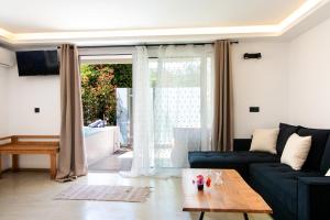 a living room with a couch and a table at Spitaki Pool House & Spitaki Jacuzzi Deluxe Suite in Corfu