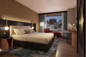 a bedroom with a bed and a view of a city at Hotel Trinity, Autograph Collection in Austin +13 photos