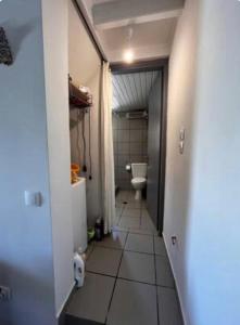 a hallway of a bathroom with a toilet and a sink at The Arch House in Kymi +36 photos