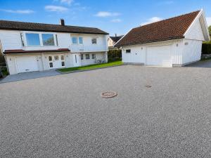 a driveway in front of a house with two garage at D&C Norway in Kristiansand