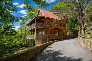 a large wooden house with a walk way to it at Mountain Tyme, Hot Tub, Pool Table, Game Room, 560 FREE tickets each paid day! in Sevierville