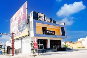 a building with a woco sign on the side of it at Hotel O KSR GRAND in Maula Ali +20 photos