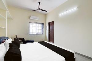a bedroom with a white bed and a window at Hotel O KSR GRAND in Maula Ali