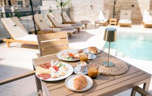 a table with plates of food and drinks on it at Boutique Hotel Zara in Ulcinj