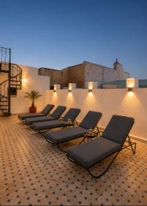 a row of chaise lounge chairs in a room at RIAD YOUSSEF in Fez