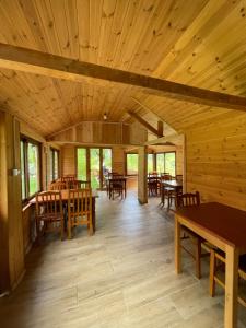 a large room with wooden tables and chairs at Bujtina Pllumi Theth in Theth