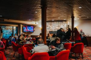 a group of people sitting at tables in a restaurant at The Highlands at Harbor Springs in Harbor Springs +28 photos