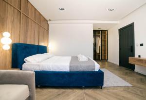 a bedroom with a blue bed and a couch at Boutique Hotel Zara in Ulcinj +86 photos
